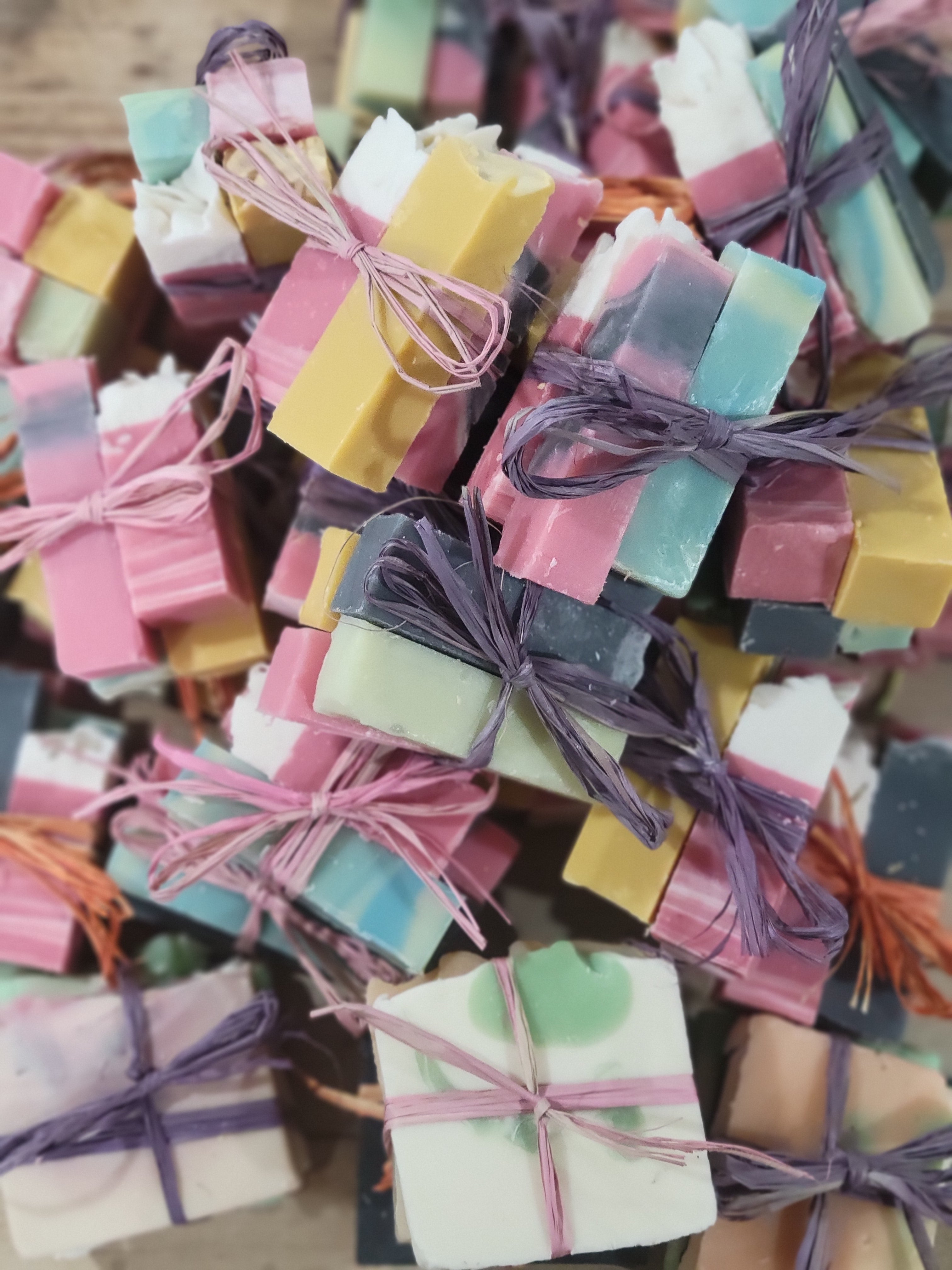 Organic goat milk soap sample pack, handmade and vegan, featuring colorful mini bars tied with string. Perfect for sensitive skin.